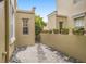 Charming backyard featuring a stone walkway, pebble landscaping, and a private gated entrance at 2419 Victoria Gardens Ln, Tampa, FL 33609