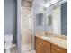 Bathroom featuring granite countertop vanity with a glass shower and tiled floors at 2419 Victoria Gardens Ln, Tampa, FL 33609