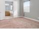 Neutral bedroom showcasing plush carpeting, a window with blinds, and an ensuite bathroom at 2419 Victoria Gardens Ln, Tampa, FL 33609
