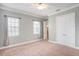 Spacious bedroom with plush carpeting, crown molding, and a view into the ensuite bathroom at 2419 Victoria Gardens Ln, Tampa, FL 33609