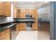 Bright kitchen featuring stainless steel appliances, granite countertops and wood cabinetry at 2419 Victoria Gardens Ln, Tampa, FL 33609