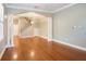 Spacious living room featuring hardwood floors, an arched doorway, and a staircase at 2419 Victoria Gardens Ln, Tampa, FL 33609