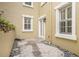 Secluded patio space with stone pavers, pea gravel and lush plants at 2419 Victoria Gardens Ln, Tampa, FL 33609