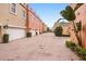 Charming street view with a brick paved road lined with private garages and tasteful landscaping at 2419 Victoria Gardens Ln, Tampa, FL 33609