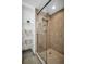 Shower with glass door, tiled walls, shelves, and updated shower head at 2730 5Th Ct, Palm Harbor, FL 34684