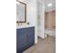 This bathroom features a blue vanity, white countertop, and a gold framed mirror at 2730 5Th Ct, Palm Harbor, FL 34684