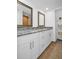 Bathroom with double vanity, granite countertop, and storage shelves at 2730 5Th Ct, Palm Harbor, FL 34684