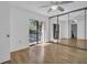 Bright bedroom features wood floors, mirrored closet, and sliding doors leading to a balcony at 2730 5Th Ct, Palm Harbor, FL 34684