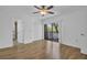 Bright bedroom features wood floors, ceiling fan, closet and sliding doors leading to a balcony at 2730 5Th Ct, Palm Harbor, FL 34684