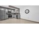Updated kitchen with stainless steel appliances, sleek gray cabinets, and tile floors, providing a modern cooking space at 2730 5Th Ct, Palm Harbor, FL 34684