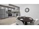 Modern kitchen featuring stainless steel appliances, gray cabinetry, tile backsplash, and an adjacent dining area at 2730 5Th Ct, Palm Harbor, FL 34684