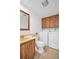 A laundry room with a sink, toilet, cabinets, washer, and dryer at 2730 5Th Ct, Palm Harbor, FL 34684