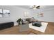 A furnished living room with a decorative couch, rug, table, and mounted decor at 2730 5Th Ct, Palm Harbor, FL 34684