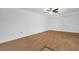 A spacious, empty living room with hardwood flooring and a ceiling fan at 2730 5Th Ct, Palm Harbor, FL 34684