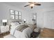 An elegant main bedroom with a neutral color palette, hardwood floors, and ensuite bathroom at 2730 5Th Ct, Palm Harbor, FL 34684