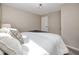 Bright bedroom with neutral walls, soft carpet, and white bedding at 6923 Dartmouth N Ave, St Petersburg, FL 33710