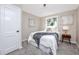 Calm bedroom with neutral walls, soft carpet, and natural light from window at 6923 Dartmouth N Ave, St Petersburg, FL 33710
