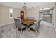Cozy dining room featuring a rustic wood table with upholstered chairs, carpet flooring, and a decorative chandelier at 6923 Dartmouth N Ave, St Petersburg, FL 33710