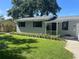 Charming single-story home with beautiful landscaping and dark shutters on the windows at 6923 Dartmouth N Ave, St Petersburg, FL 33710