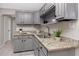 Updated kitchen featuring granite countertops, gray cabinets, and modern fixtures at 6923 Dartmouth N Ave, St Petersburg, FL 33710