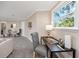 Bright living room with an adjacent desk area, plush carpeting, and a large window at 6923 Dartmouth N Ave, St Petersburg, FL 33710