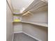 Cozy walk-in closet with carpet and built-in shelving with storage space at 6923 Dartmouth N Ave, St Petersburg, FL 33710