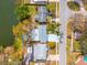 Aerial view of home with large lot on a lake with mature landscaping and lush green trees at 8501 47Th N St, Pinellas Park, FL 33781