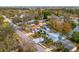Aerial view of a charming home near a tranquil lake, surrounded by lush trees and a serene neighborhood at 8501 47Th N St, Pinellas Park, FL 33781