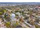 A neighborhood aerial view showcasing a charming home near a pond with nearby Park water tower at 8501 47Th N St, Pinellas Park, FL 33781