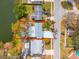 Aerial view of home with large lot on a lake with mature landscaping and lush green trees at 8501 47Th N St, Pinellas Park, FL 33781