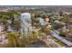 A neighborhood aerial view showcasing a charming home near a pond with nearby Park water tower at 8501 47Th N St, Pinellas Park, FL 33781