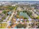 Expansive aerial shot shows a waterfront home nestled in a mature neighborhood with tree-lined streets at 8501 47Th N St, Pinellas Park, FL 33781