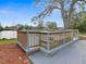 Image shows a back deck overlooking the water and surrounded by a light wood railing at 8501 47Th N St, Pinellas Park, FL 33781