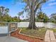 Scenic backyard with a large tree, lake, and a wooden deck for outdoor enjoyment at 8501 47Th N St, Pinellas Park, FL 33781
