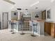 Finished basement bar with bar stools, a wood countertop and glass block base at 8501 47Th N St, Pinellas Park, FL 33781