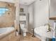 Bathroom features tub, toilet, and pedestal sink at 8501 47Th N St, Pinellas Park, FL 33781