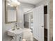 Bathroom features pedestal sink and views to a large living area at 8501 47Th N St, Pinellas Park, FL 33781