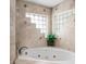 Corner jetted tub with travertine tile and decorative accents at 8501 47Th N St, Pinellas Park, FL 33781