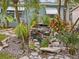 Landscaped front yard with mature trees and a beautiful waterfall feature at 8501 47Th N St, Pinellas Park, FL 33781