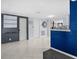 Hallway with white tiled floors and neutral walls, providing access to multiple rooms at 8501 47Th N St, Pinellas Park, FL 33781