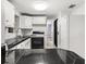 Compact kitchen with white cabinets, dark countertop and stainless steel faucet at 8501 47Th N St, Pinellas Park, FL 33781