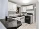 Bright kitchen featuring white cabinetry, subway tile backsplash, and black appliances at 8501 47Th N St, Pinellas Park, FL 33781