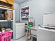 This is the laundry room, complete with a washer, dryer, and shelving at 8501 47Th N St, Pinellas Park, FL 33781