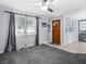 Inviting living room with a wooden front door, ceiling fan, natural light, and plush carpeting at 8501 47Th N St, Pinellas Park, FL 33781