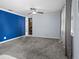 Cozy living room featuring a ceiling fan, modern lighting, and plush gray carpeting at 8501 47Th N St, Pinellas Park, FL 33781