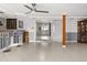 Open living room with tile floors, ceiling fan, wet bar, and sliding doors to the backyard at 8501 47Th N St, Pinellas Park, FL 33781