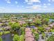 Aerial view of the property with mature landscaping and a lovely pond with a fountain in beautiful Clearwater, Florida at 880 S Village Lake N Dr # 106, St Petersburg, FL 33716