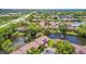 An aerial view of a community showcasing lush landscaping and a serene lake with fountains, creating a peaceful ambiance at 880 S Village Lake N Dr # 106, St Petersburg, FL 33716