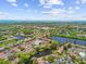 An aerial view featuring a serene lake with fountains and recreational amenities for tranquil community living at 880 S Village Lake N Dr # 106, St Petersburg, FL 33716