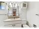 Bathroom featuring a single sink vanity, mirror, and commode at 880 S Village Lake N Dr # 106, St Petersburg, FL 33716